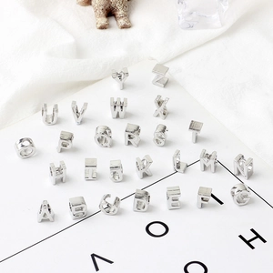 Silver metal A-Z letter charms for DIY bracelet making jewelry on white background