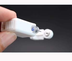 Macro shot of disposable ear piercing tool with blue crystal stud and stainless steel needle