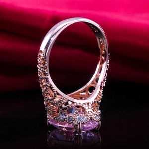 Rose gold ring featuring a large oval pink zircon and vintage hollow patterns