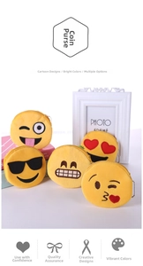 Detailed view of five plush yellow emoji coin purses with metal zippers and chain hooks
