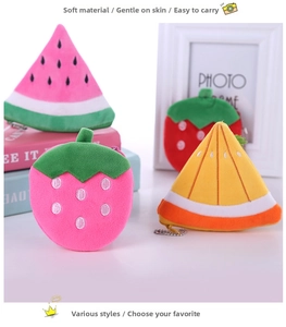 Detail of plush fruit pouches featuring watermelon, strawberry and orange with metal chains