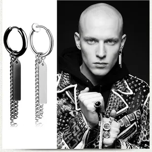 Detail of punk style tassel chain earrings with rectangular pendants in black and silver