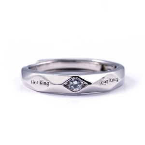Macro view of silver faceted couple ring engraved with Her King text and small gemstone