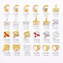 Macro shot of 24 alloy nail art charms featuring hearts, crowns, and pearls