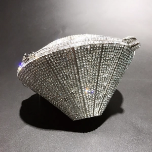 Detailed macro view of silver luxury diamond-shaped evening clutch bag with sparkling crystals