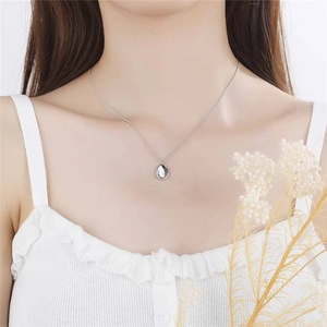 Minimalist S925 sterling silver necklace with smooth oval pendant on a female model