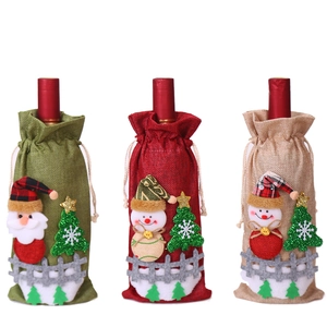 Three Christmas burlap wine bottle covers with Santa and snowman 3D dolls for table decor