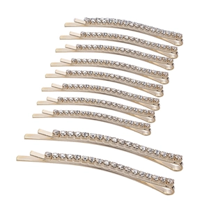 Set of 10 golden rhinestone hair clips with sparkling crystals on white background