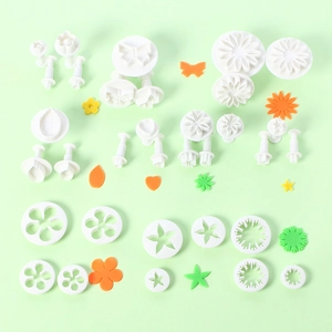 Detailed set of white fondant cutters in flower, leaf, heart and star shapes