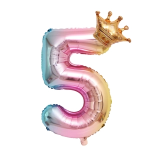 Macro shot of gradient rainbow number 5 foil balloon with a golden crown detail
