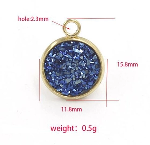 Macro detail of round gold stainless steel pendant with blue glitter and size markings