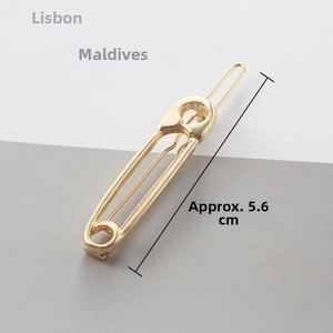 Detailed view of a 5.6cm gold safety pin hair clip in minimalist polished alloy