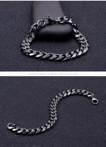 Macro shot of black brushed stainless steel curb link chain bracelet with lobster clasp