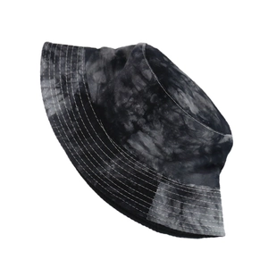 Detailed view of tie-dye bucket hat featuring black and white patterns and decorative stitching