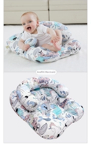 Close-up of portable baby lounger with doodle mermaid pattern and U-shaped safety bumper