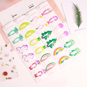 Detail of colorful cartoon hair clips featuring elephant and flamingo on display cards