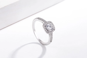 Macro view of square halo silver ring featuring central clear stone and diamond accents