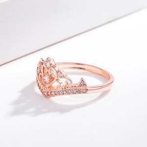 Macro shot of 18K rose gold plated crown ring with pavé zircons and a central diamond