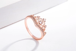 Detail of rose gold crown ring with sparkling zircon stones in a princess style