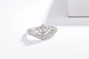 Detailed view of 18K silver crown ring with heart filigree and brilliant zircon setting
