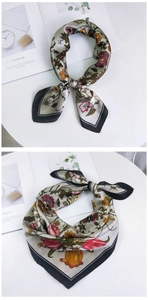 Detail of olive green floral silk scarf with tulip prints and black border finish