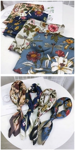 Detail of floral silk scarf set featuring dragonfly prints and elegant satin texture