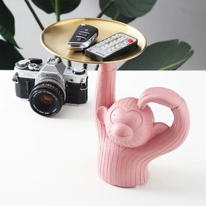 Pink monkey figurine with golden tray for desk organization and home decoration