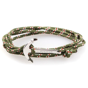 Detailed macro view of the silver Vikings anchor clasp on a green braided nautical bracelet