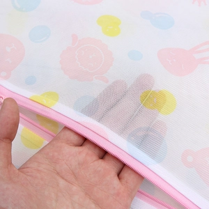 Fine mesh laundry bag with rabbit and cartoon prints featuring a pink protective zipper
