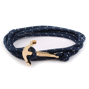 Detail view of navy blue nautical rope bracelet with a gold-toned VIKINGS anchor clasp
