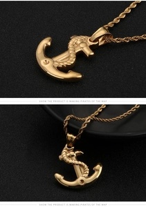 Detailed view of a gold anchor pendant with nautical rope design and a twisted chain