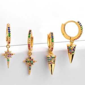 Detail of gold earrings with rainbow cubic zirconia star and cone shaped pendants