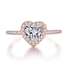 Macro shot of rose gold heart ring with halo setting and pavé diamonds on the band