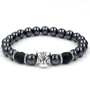 Macro shot of silver leopard head bead and volcanic stones on hematite bracelet