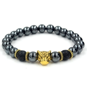 Detailed shot of beaded bracelet featuring gold leopard head and black volcanic stone beads