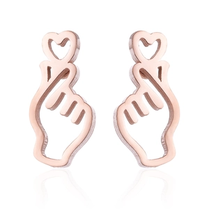 Close-up of rose gold wave stud earrings in heart finger gesture design on white base