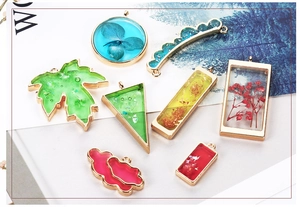 Detailed shot of alloy open frames with dried flowers and sequins for DIY jewelry