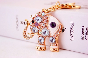 Macro detail of elephant keychain with sparkling crystals and white enamel finish