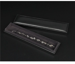 Detail of silver hollowed bracelet in black gift box with soft grey velvet interior