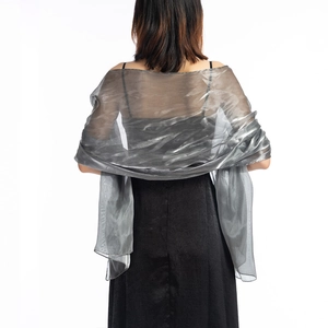 Close-up of translucent grey silk shawl texture with elegant glossy sheen for evening wear