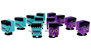 Macro view of Frankenstein and Vampire wind-up walking toys with mechanical knobs