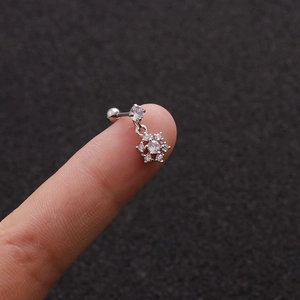 Macro view of silver snowflake earring with zircon stones and screw ball backing