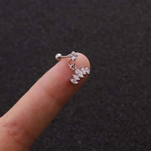 Macro shot of silver stainless steel helix piercing with marquise cut zircon drop