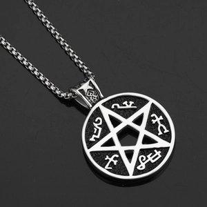 Macro shot of a pentagram hip hop pendant with symbolic textures on a black surface