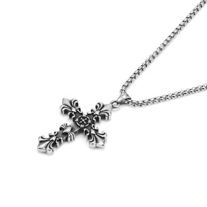 Macro view of silver vintage cross pendant with intricate textures on hip hop necklace