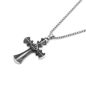 Detailed close-up of a hip-hop cross pendant with crown motif and polished silver box chain