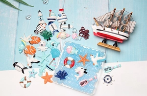 Close-up of ocean theme resin charms including starfish and anchors for DIY crafts