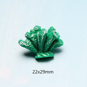 Macro shot of 22x29mm green resin coral charm with white spots for DIY crafting