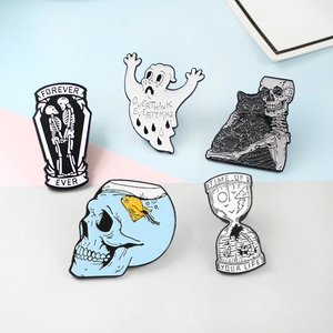 Detailed close-up of gothic enamel pins set featuring skeleton, ghost and hourglass designs