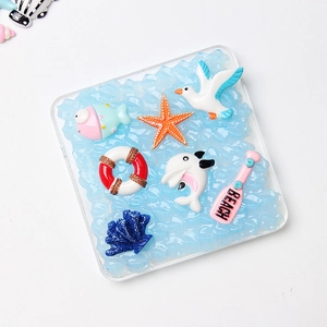 Handmade ocean themed resin coaster with anchor, starfish and beach charms on blue waves